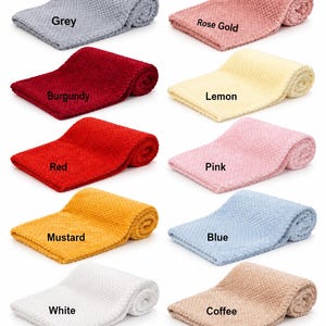May include: A collection of ten folded blankets with a textured waffle-knit pattern, each labeled with its color: Grey, Rose Gold, Burgundy, Lemon, Red, Pink, Mustard, Blue, White, and Coffee. The blankets are arranged in two columns.