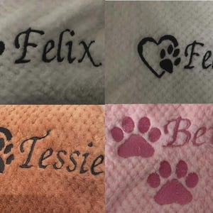May include: A collage of four textured fabric swatches featuring embroidered designs. The top left shows a black paw print and the name Felix. The top right shows a heart with a paw print and the name Felix. The bottom left shows a heart with a paw print and the name Tessie. The bottom right shows two pink paw prints and the name Betsy.