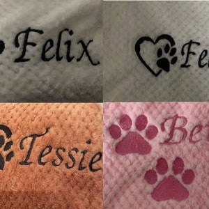 May include: A collage of four textured fabric swatches featuring custom embroidery. The designs include the names Felix, Tessie, and Betsy in script font, accompanied by black or pink embroidered paw prints and heart motifs.