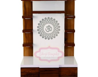May include: A white wooden temple with a decorative Om symbol and shelves. The temple has a white top and a brown base with two drawers. The text "Shriji Temples" is printed on the front of the temple.
