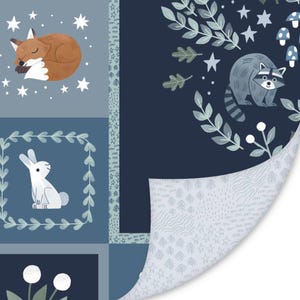 May include: A fabric featuring a patchwork design with illustrations of a sleeping fox, a white rabbit in a leafy frame, and a raccoon surrounded by foliage and stars. The reverse side shows a light gray pattern of trees, stars, and wavy lines.