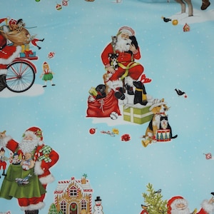 Santa Riding a Bike, Santa with Presents in Blue Mary Lake-Thompson by Robert Kaufman Fabrics Quilting Cotton Fabric AMKD204854
