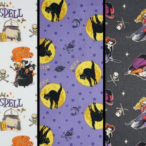 May include: Three vertical fabric panels featuring Halloween-themed prints. The left panel is white with cauldrons, skulls, and the text I Put a Spell on You. The center panel is purple with black cats on yellow moons and the word Binx. The right panel is dark gray with flying witches and skulls.