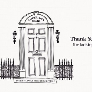 A black and white illustration of a studio entrance with a sign that says "Kitty Bloom Studio" and a decorative arch above the door. There is a small plaque on the door that reads "Home of Lovely Cross Stitch Fabric".