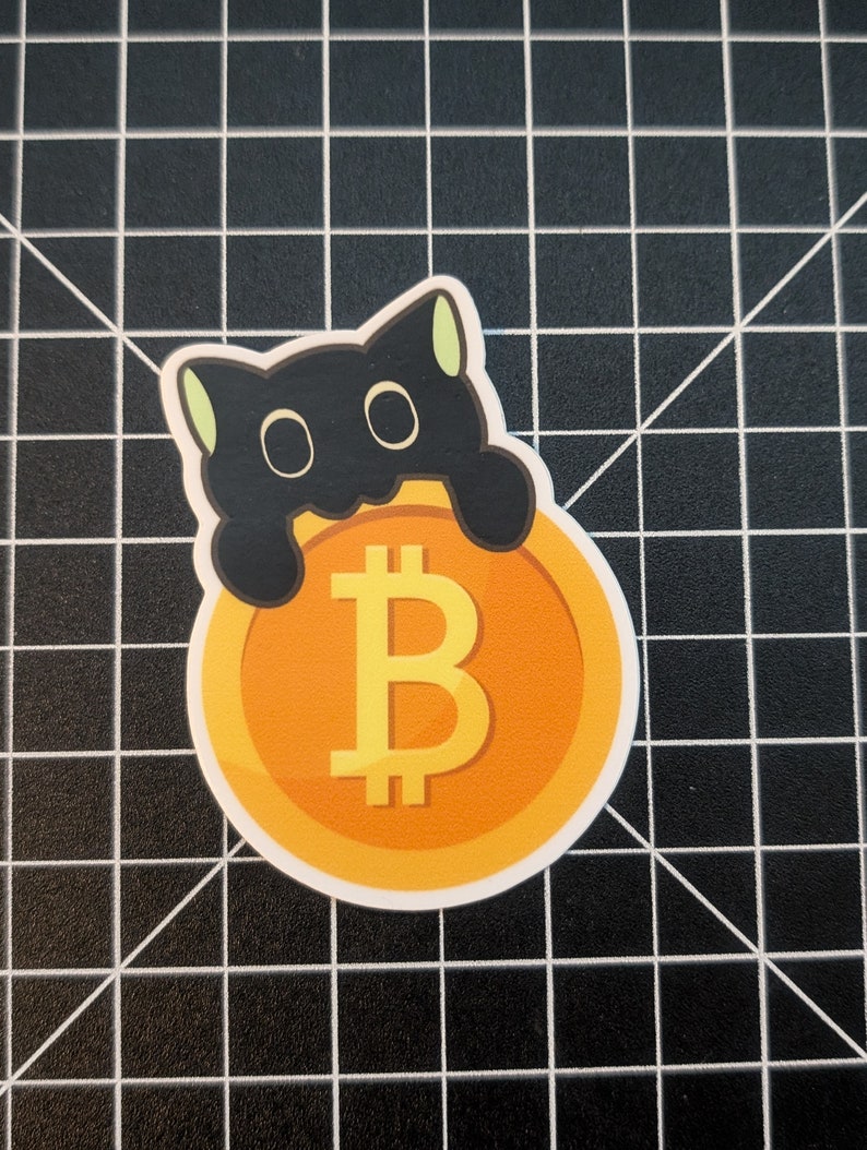 May include: A black cat sticker with green ears holding a gold coin with a Bitcoin symbol.