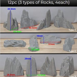 May include: A collection of twelve grey artificial rocks, divided into three types with four of each. The largest rock measures 44.5mm high and 49.5mm wide. The image includes text: "12pc (3 types of Rocks, 4each)".