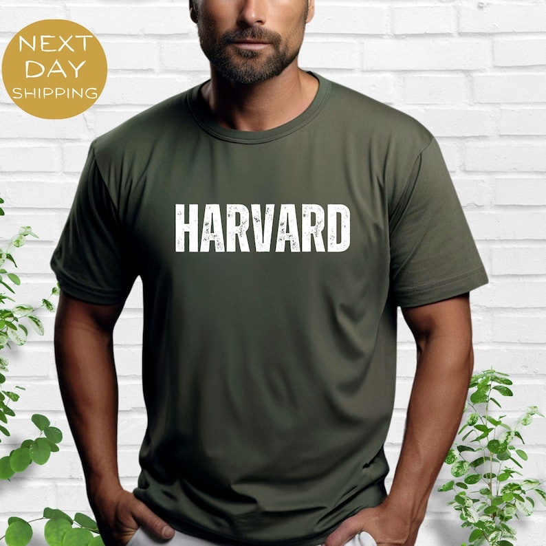 May include: A dark green t-shirt with the word "HARVARD" printed in white on the front.