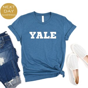May include: A blue t-shirt with the word "YALE" printed in white on the front.