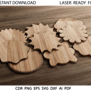 Puede incluir: Un conjunto de posavasos de madera en varias formas, incluyendo un engranaje, una flor y una estrella. Los posavasos son de madera clara y están dispuestos sobre una superficie de madera oscura. Se ven las palabras "INSTANT DOWNLOAD" y "LASER READY FILES".