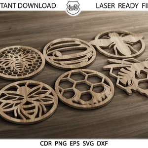 Op de afbeelding: Zes lasergesneden houten onderzetters met bijen- en honingraatontwerpen. De onderzetters zijn rond en hebben ingewikkelde details. De ontwerpen omvatten een bij met vleugels, een honingraat en een bijenkorf.