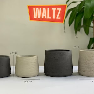 May include: Four concrete planters in different sizes. The planters are in two colors, black and beige. The planters are 4.5 inches, 6 inches, and 5.5 inches tall. The planters are 5.5 inches and 7 inches wide. The word "WALTZ" is written in red on a yellow background.