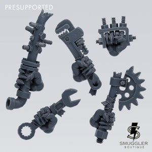 May include: Five 3D printed miniature weapons for a tabletop game. The weapons are made of gray plastic and feature a variety of tools and gears. The weapons are held in the hands of miniature figures.