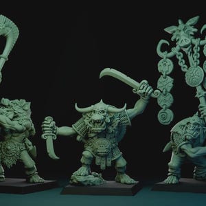 May include: Three light green fantasy miniature figurines standing on square bases. The left figure holds a club with a beast head, the center figure wields two curved blades, and the right figure carries a tall staff adorned with circular medallions.