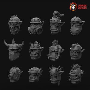 May include: Twelve different 3D printed Orc heads with various helmets and accessories. The heads are all in a gray color and are arranged in a grid pattern.
