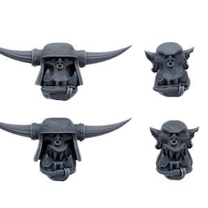 Puede incluir: Cuatro cabezas de orco de plástico gris diferentes con cuernos, algunas con cascos, para usar en juegos de guerra en miniatura.