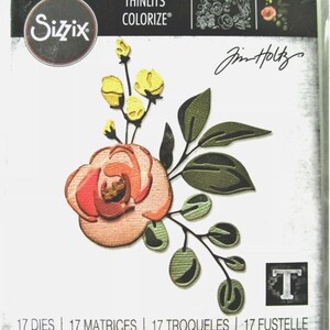 May include: Sizzix Thinlits Colorize die set featuring a floral design. The set includes a detailed rose with peach and red petals, green leaves, and yellow buds. The package also includes the text "Jim Holtz".