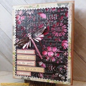 May include: Mixed media art piece featuring a dragonfly and floral cutouts in shades of pink and black. Text includes "LITTLE THINGS", "shine and sparkle", and "in the garden". The artwork has a textured, layered appearance.