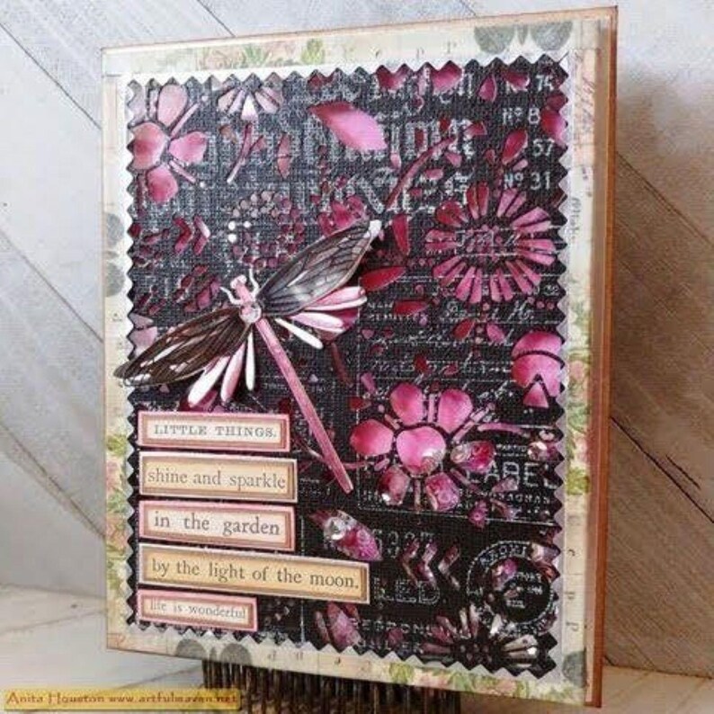 May include: Mixed media art piece featuring a dragonfly and floral cutouts in shades of pink and black. Text includes "LITTLE THINGS", "shine and sparkle", and "in the garden". The artwork has a textured, layered appearance.