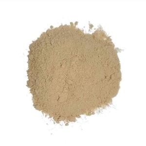 May include: A close-up of a pile of light brown powder. The powder is finely ground and has a smooth texture.