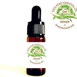 May include: A 5 ml amber glass bottle of 100% pure ginger essential oil from Madagascar. The label is green and white with the text "100% Pure Essential Oil", "Tasty Healthy Food", "Close Family Farm", "Ginger of Madagascar", and "5 ml".