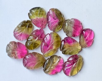 May include: A collection of carved gemstone leaves in shades of pink, yellow, and green. The gemstones are oval-shaped and feature intricate leaf vein details. The colors transition from pink to yellow to green, creating a gradient effect.