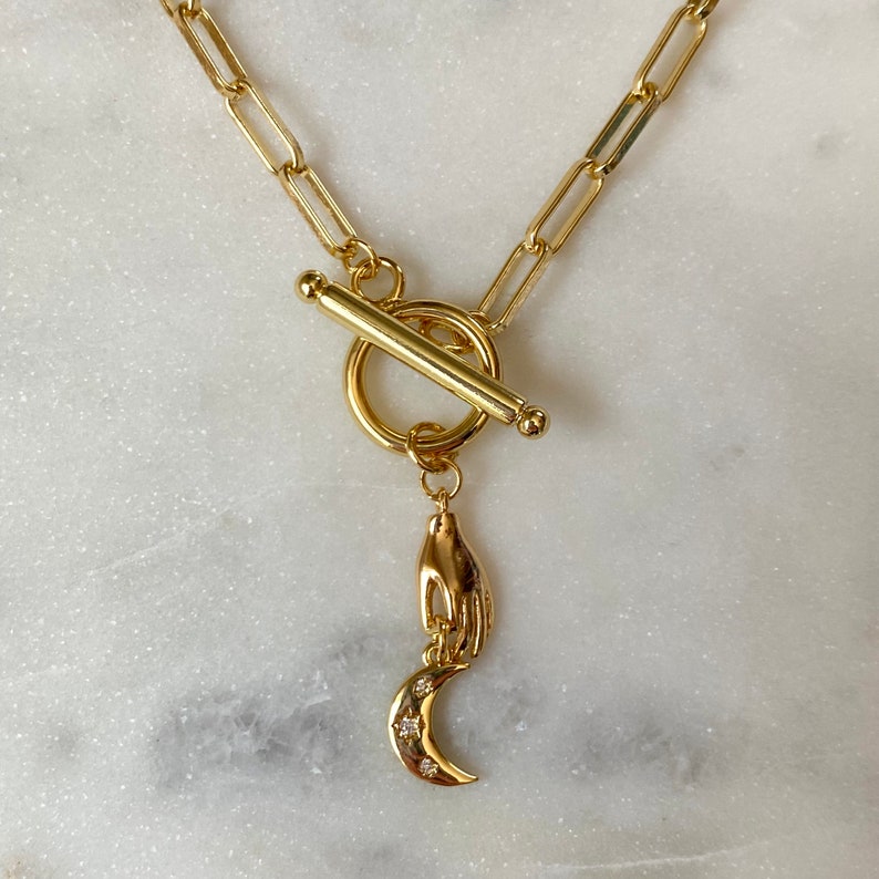 moon song | phoebe bridgers-inspired gold toggle chain necklace with hand and moon charms, 16” long 