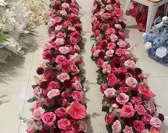 May include: Two long garlands of pink and red artificial flowers, perfect for a wedding or party decoration.