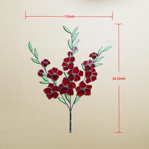 May include: A decorative floral piece featuring red flowers and green leaves. The piece is approximately 17 inches wide and 22.5 inches tall. The flowers have a stained glass appearance, with a dark outline.