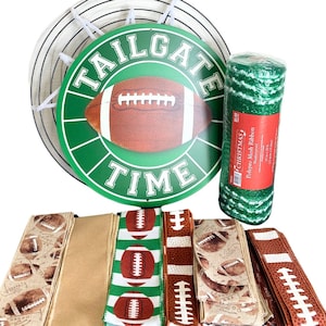 May include: A collection of football-themed decorations and craft supplies. Includes a round sign with a football graphic and the text "TAILGATE TIME", rolls of green mesh ribbon, and various ribbons with football patterns.