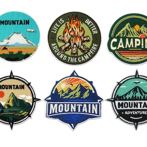 May include: Six embroidered patches with a camping theme. The patches feature mountains, campfires, and the text "Mountain", "Life is Better Around the Campfire", "Camping", and "Mountain Adventure".