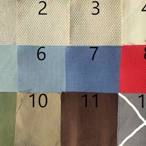 May include: A swatch card with 12 different fabric samples. The samples are numbered 1 through 12. The fabrics are in a variety of colors and textures, including beige, blue, red, green, and gray.