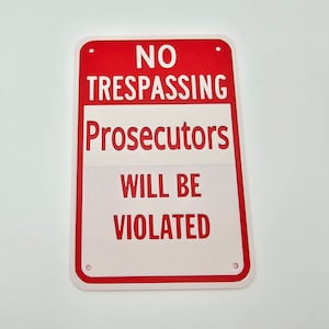 May include: Red and white sign with the text "NO TRESPASSING Prosecutors WILL BE VIOLATED".