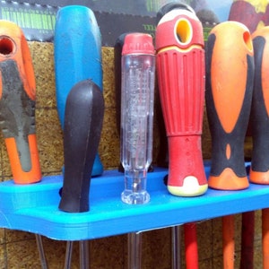 May include: A blue plastic screwdriver holder with six screwdrivers. The screwdrivers have different colored handles, including blue, red, orange, and black.