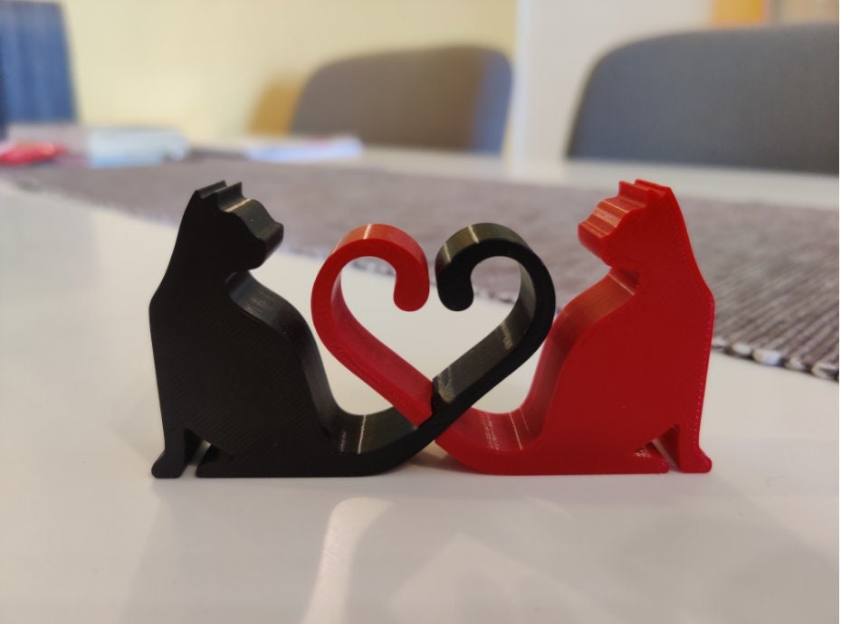 Silhouette of Two Cats with Tails Intertwined in Heart Shape