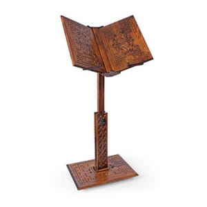 May include: A brown wooden book stand with an open book. The stand features detailed carvings on the base, stem, and book rest. The book rest is angled, and the stand is approximately 100 cm tall.