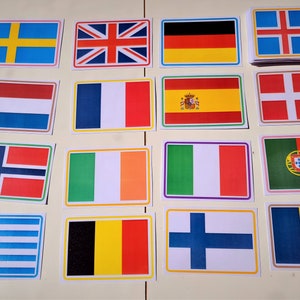 May include: A set of 16 colorful rectangular cards featuring flags of different countries. The flags are printed on white cardstock and have a colorful border.