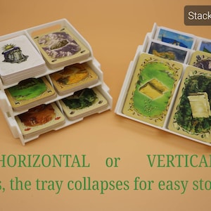 May include: White plastic tray for storing game cards. The tray can be stacked horizontally or vertically. The tray collapses for easy storage. "Stacked Tray" is written on the image.