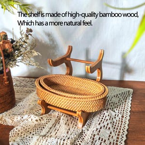 May include: Two woven wicker baskets on a wooden stand. The stand has a natural wood finish and is made of bamboo. The baskets are oval shaped and have a natural brown color.