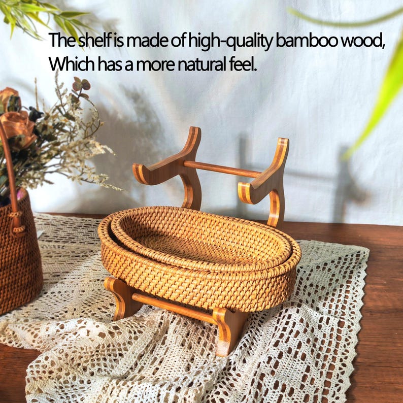 May include: Two woven wicker baskets on a wooden stand. The stand has a natural wood finish and is made of bamboo. The baskets are oval shaped and have a natural brown color.