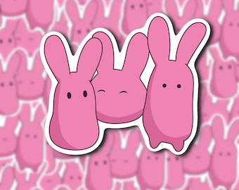 May include: Three pink cartoon bunny stickers with white outlines. The bunnies have black eyes and are smiling. The stickers are on a pink background.