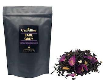 May include: A black pouch with a white label that reads "Camellios Earl Grey" and a description of the tea blend. The pouch contains loose leaf Earl Grey tea with rose petals, bergamot, and orange. The tea is hand blended in the UK and has a minimum net weight of 200g.