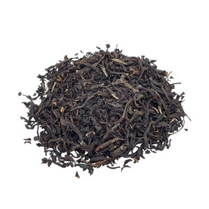 May include: A pile of loose leaf black tea, with a dark brown color and a slightly curled shape.