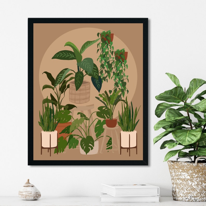 May include: A framed print of a botanical illustration featuring a variety of potted plants in a light brown room. The plants are arranged in a cluster, with some hanging from the ceiling. The print is framed in black.
