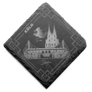 Könnte beinhalten: Schwarzer Schieferuntersetzer mit einem weißen Design der Kölner Dom und dem Text "KÖLN" und "Station".