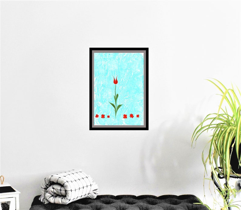 May include: Framed artwork featuring a single red tulip with green stem and leaves on a light blue background.  Four smaller red flowers are at the bottom of the image.