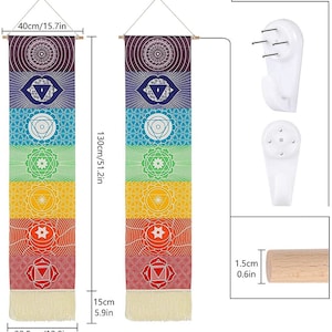 May include: A set of two colorful wall tapestries featuring the seven chakras. Each tapestry is 51.2 inches tall and 12.8 inches wide. The tapestries are made of fabric and have a fringe at the bottom. The tapestries are hung on a wall with a wooden dowel rod and come with two white wall hooks.