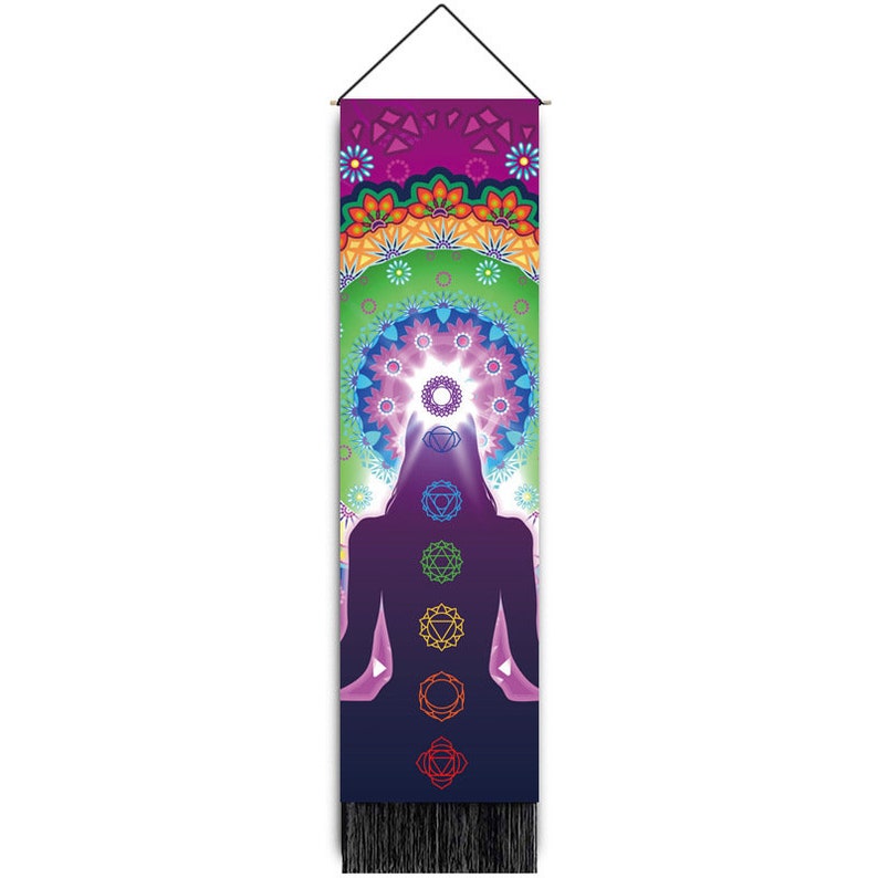 May include: A colorful tapestry featuring a silhouette of a person in a meditative pose with seven chakras represented by colorful symbols. The tapestry has a mandala design at the top and a fringe at the bottom.