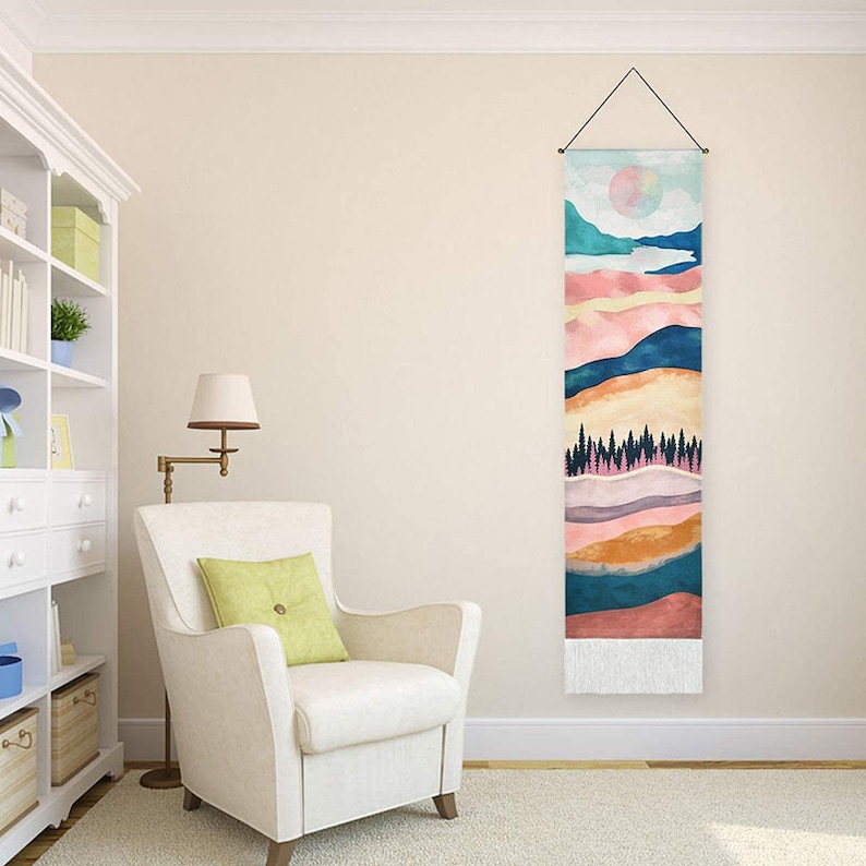 May include: A colorful abstract landscape wall tapestry with a watercolor style. The tapestry features a pink, orange, yellow, blue, and green color scheme with a white fringe at the bottom.