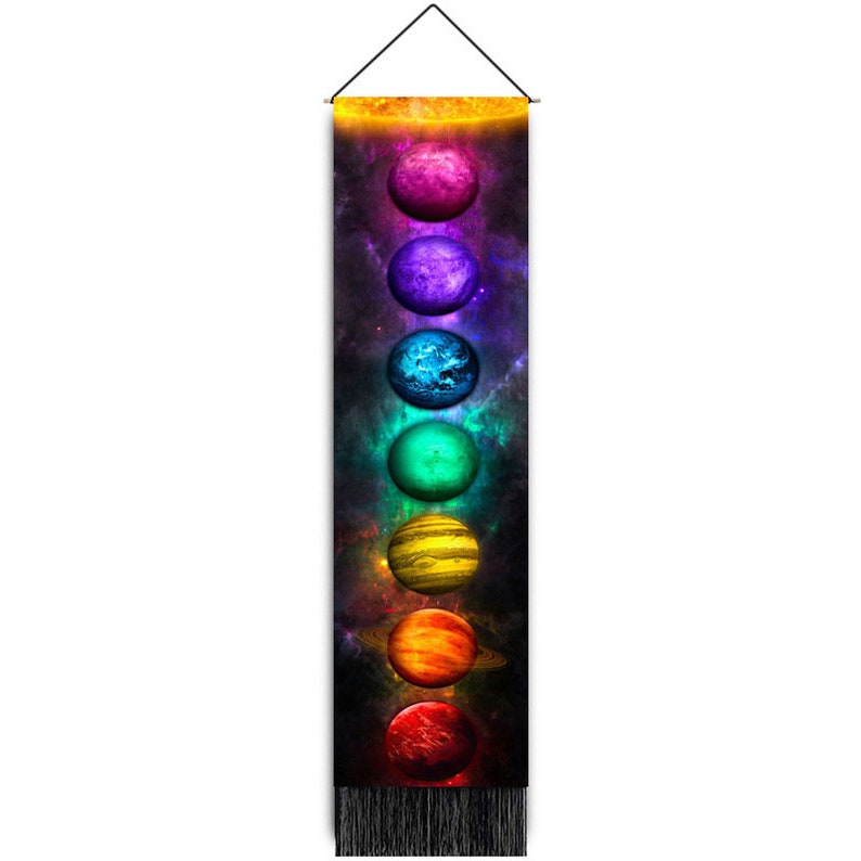 May include: A tapestry with a black background and a galaxy design. Seven planets are arranged vertically in a rainbow color pattern, with a sun at the top.