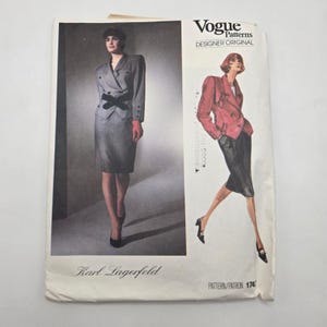 May include: A Vogue Patterns Designer Original sewing pattern envelope for a Karl Lagerfeld suit. The front displays a photograph of a grey blazer and skirt ensemble with a black belt, alongside a fashion illustration of a red blazer and black skirt.